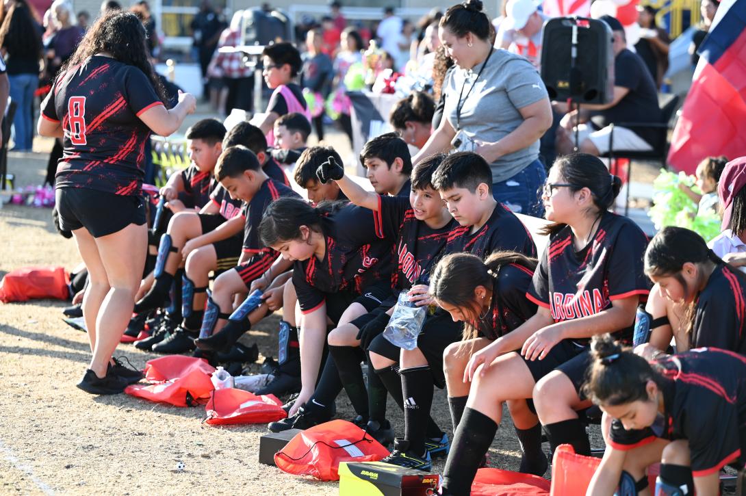 A group of soccer players put on their gear