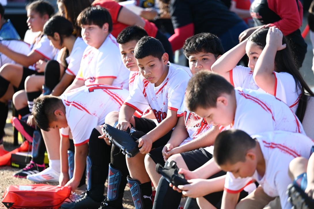 A group of soccer players put on their gear