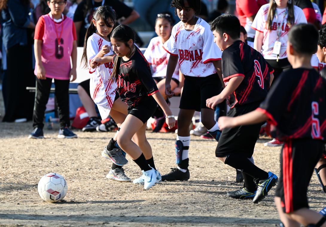 A young soccer player prepares to kick the ball