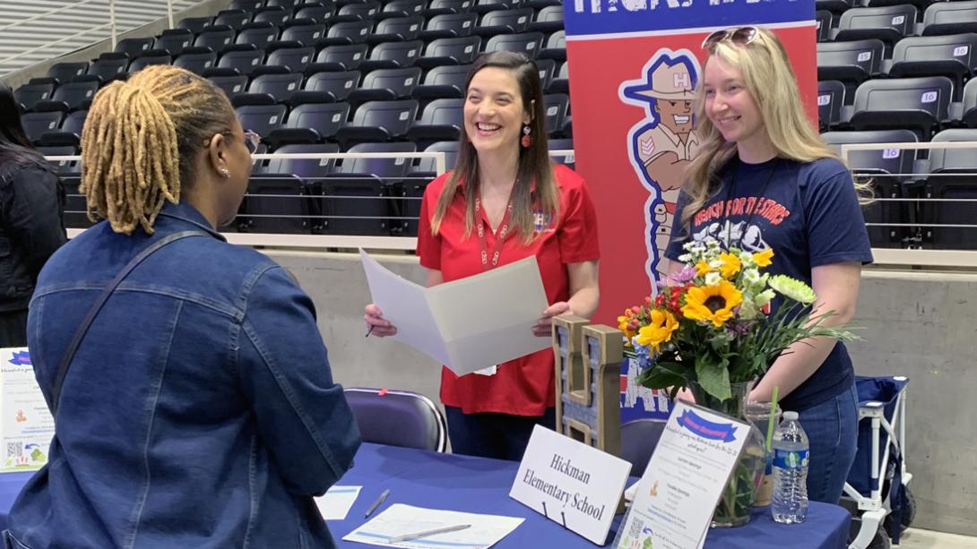 Hickman Elementary staff members smile while chatting with a candidate.