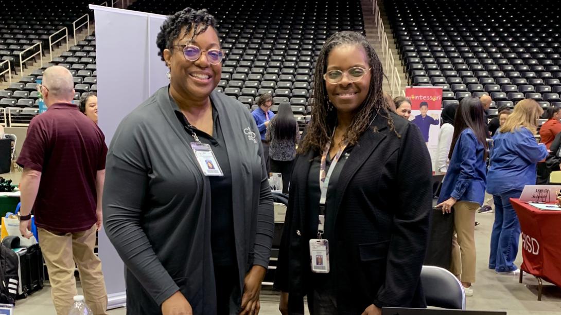 Guidance and Counseling staff members smile at their job fair table.