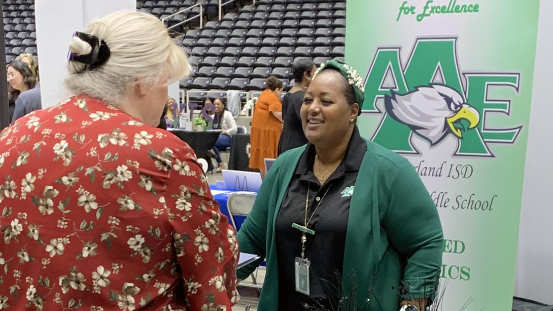 An Austin Academy staff member smiles while giving a pitch.