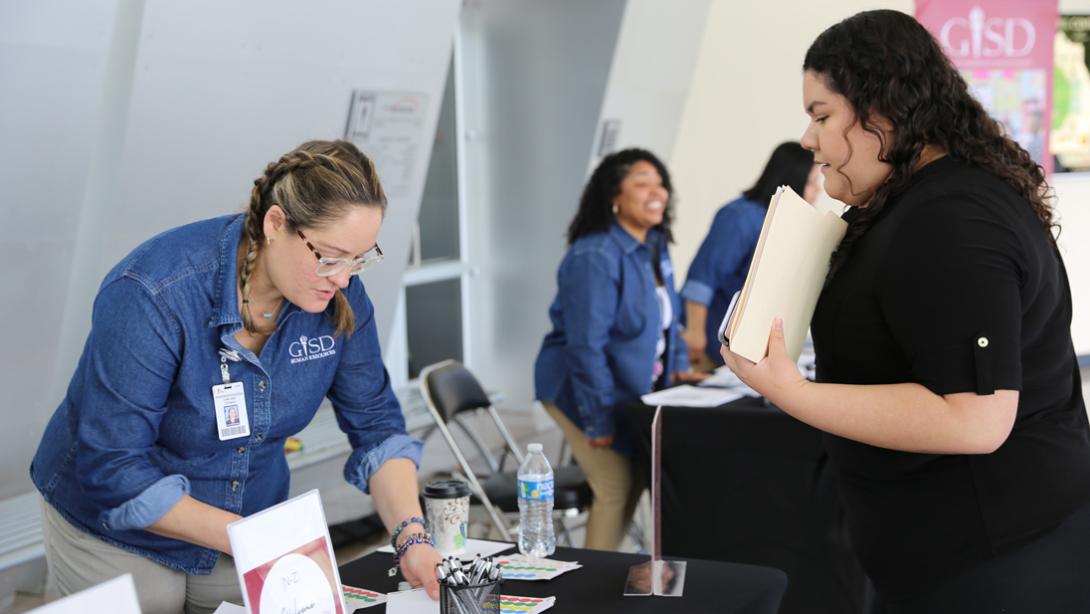 An HR member organizes resources to give to a candidate.