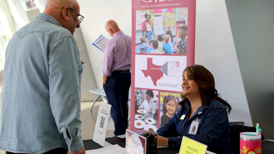 An HR member smiles while helping a candidate.