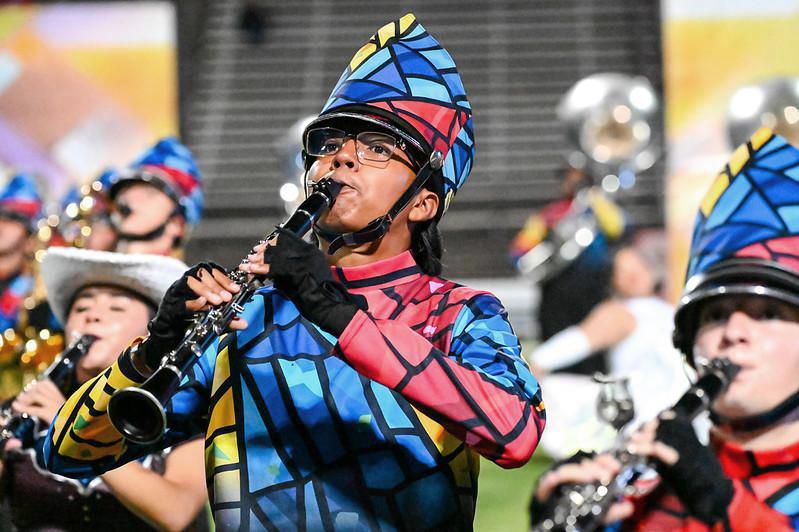 Close up of brightly-costumed clarinet player in marching band