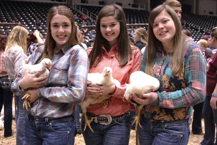 Girls holding chickens