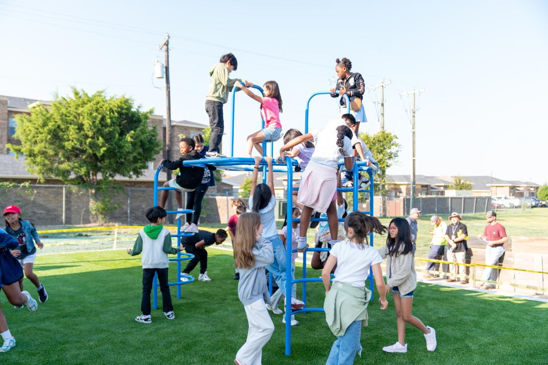 Several students play on the playground equipment