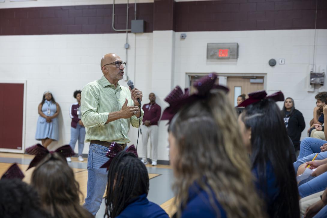 Dr. Lopez addresses a large group of students