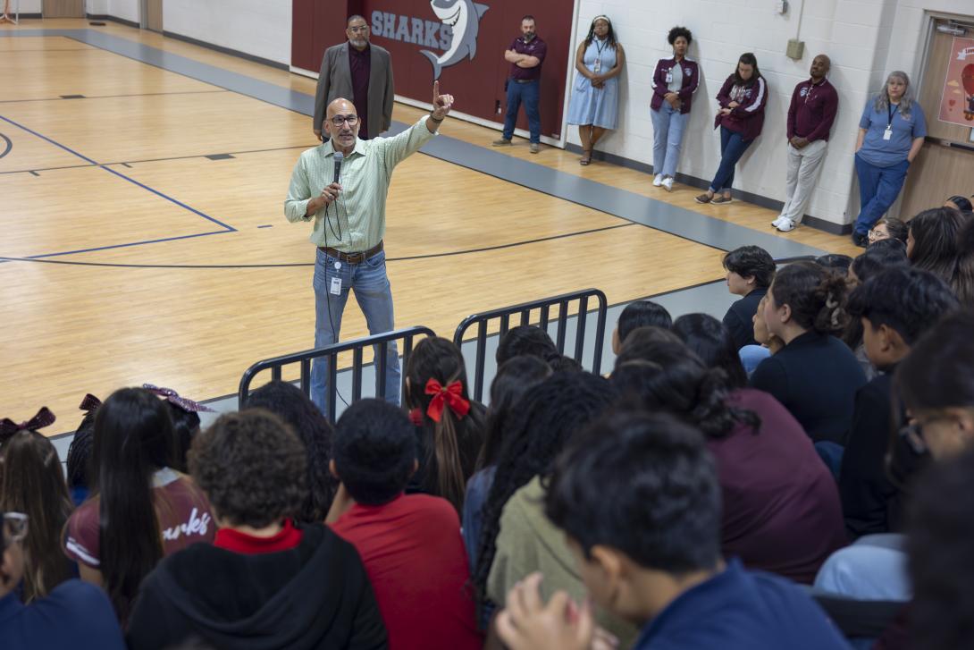 Dr. Lopez addresses a large group of students