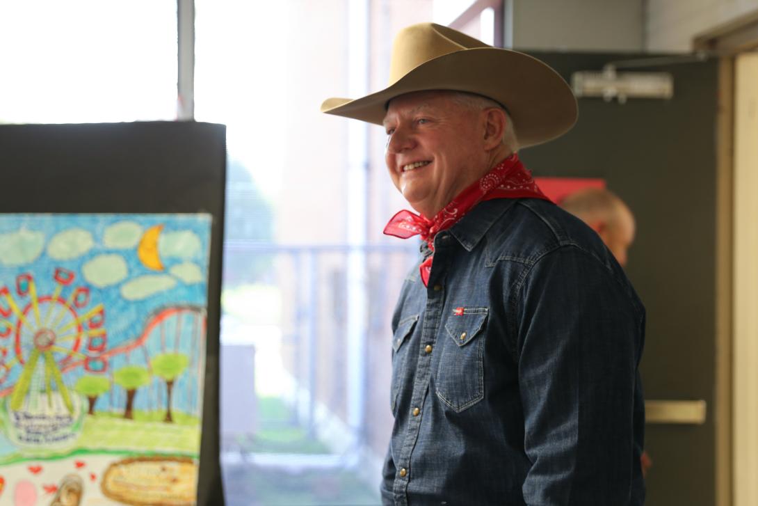 Man dressed as Big Texas greets students