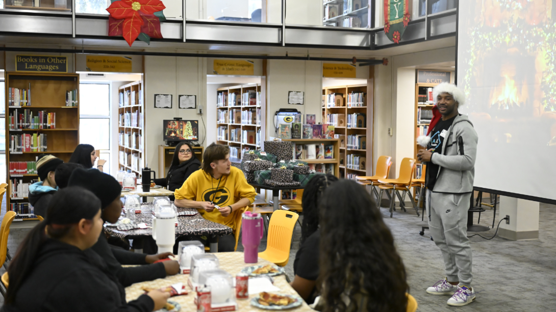 A group of students listen to a speaker 