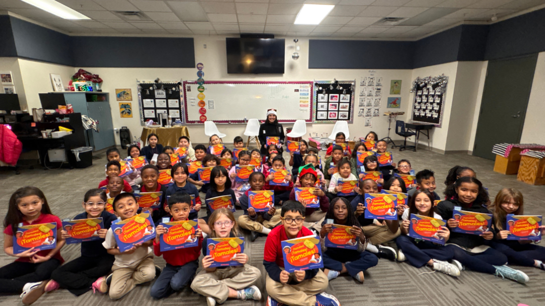A group of students pose with their books