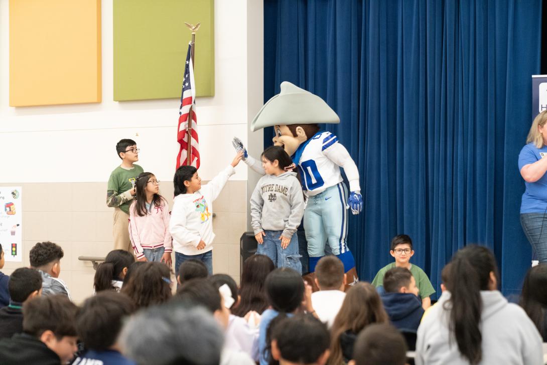 Dallas Cowboys mascot high fives a student