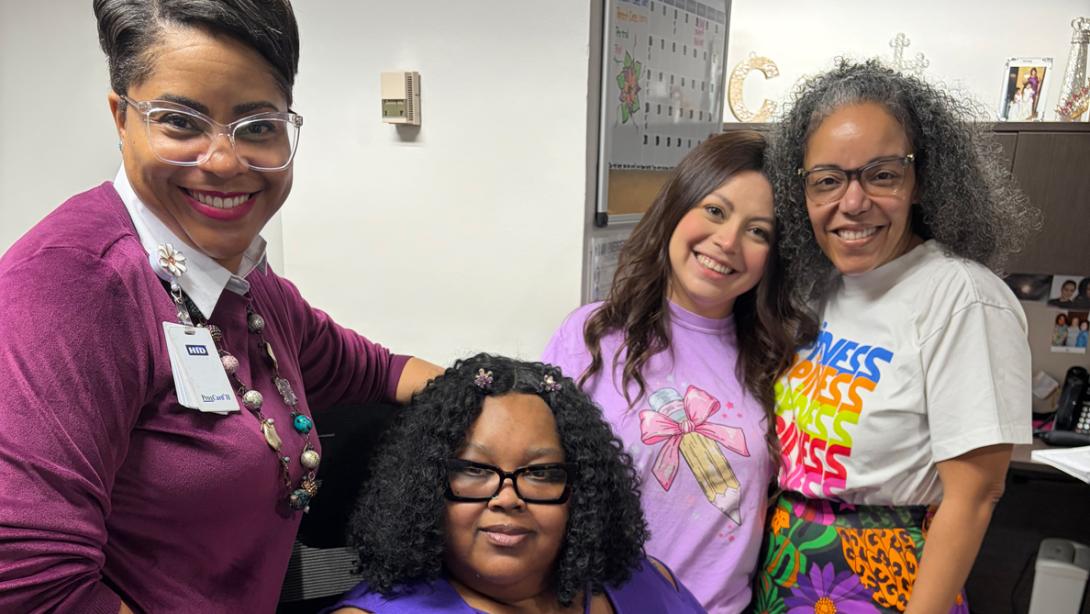 Garland ISD staff smile for a photo for Month of the Military Child.