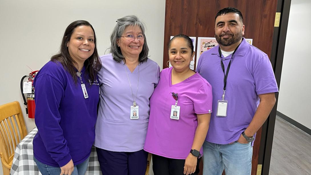 Employees from our Student Services Clinic pose in purple.
